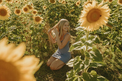 girl in sunflower field for senior portraits