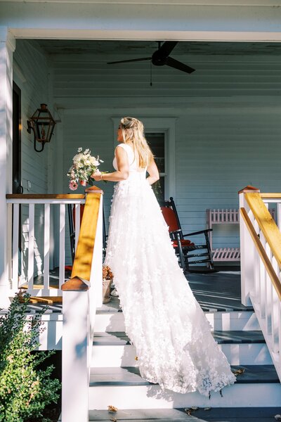Bride walking up steps of a house