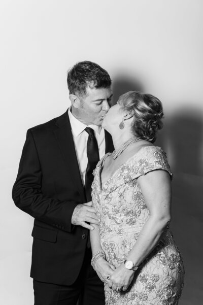 Romantic black and white portrait of a couple sharing a kiss at a Vogue Portrait photo booth in Richmond, VA.