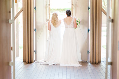 Two brides leave Marty Leonard Chapel in Fort Worth after their wedding ceremony . Taken by Danni Lea Photography., DFW Wedding Photographer.
