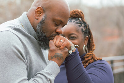 A joyful black couple in Chicago celebrating their engagement with a romantic city backdrop.