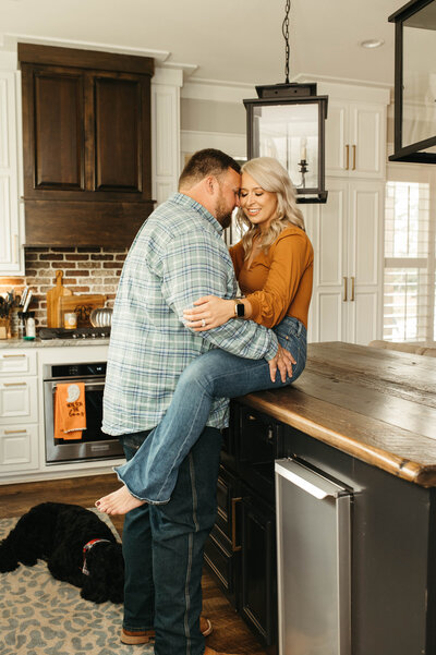 A couple at home sitting on kitchen counter