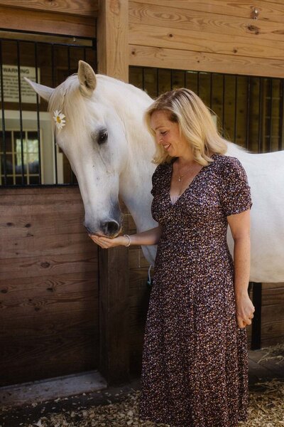 Leiko and her horse sharing a quiet moment inside a barn at Peace Horse Collective