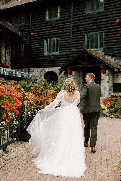 The bride and groom walking hand in hand up the steps to their wedding venue at Chateau Montebello