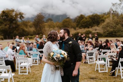 bride and groom kissing during wedding ceremony