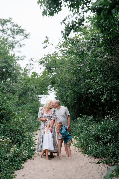 A family hugging during their portrait session on the beach in Cape May, New Jersey.