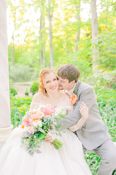 A couple canoodles under the Gramercy Mansion gazebo for Maryland Wedding Photographer