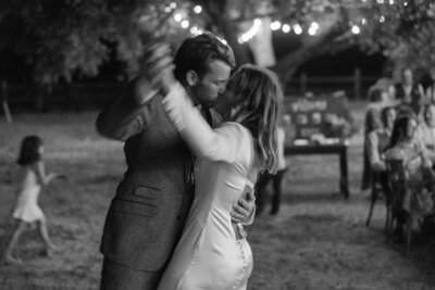 mother of the groom hugs bride after ceremony in a crowd