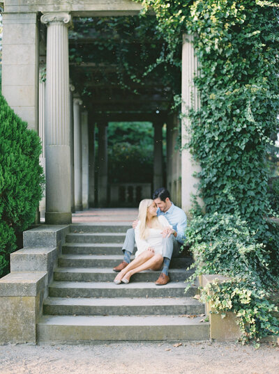 Bride and Groom sitting on the steps in the garden