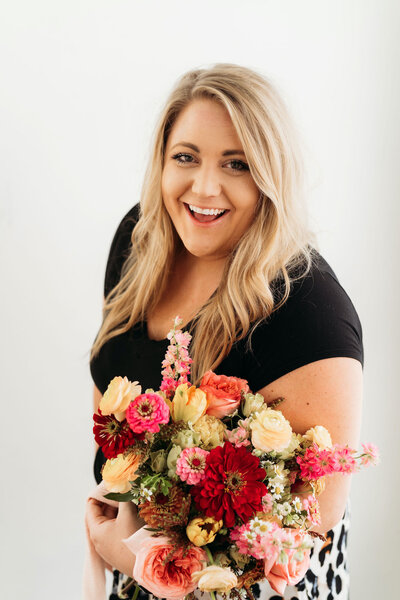 Floral designer Megan Reiley holding a bouquet