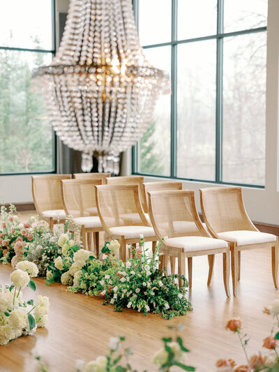 Wedding ceremony design in Michigan with elegant chairs and white florals.