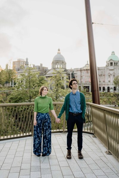 A couple stand side by side in Aberdeen's Union Terrace Gardens and pose for engagement photos.
