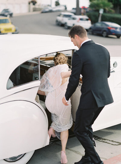 bride and groom get into classic car in san diego with destination wedding photographer Jacqueline Benét Photography
