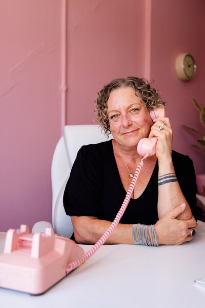 Lawyer Cassie Peters smiles on the phone. 