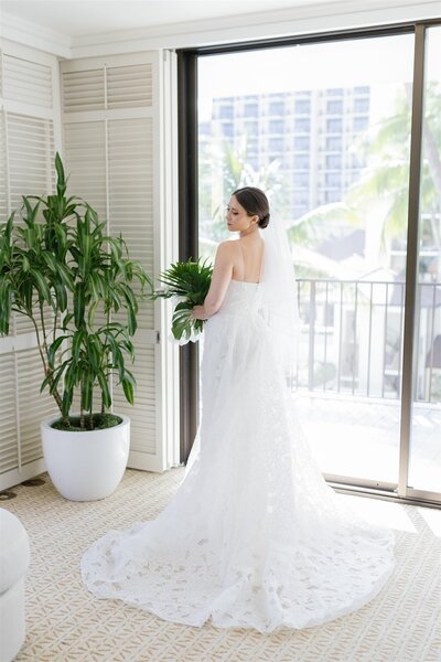 A person in a wedding dress looking over their shoulder 