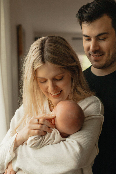 Newborn baby being rubbed by mom at home