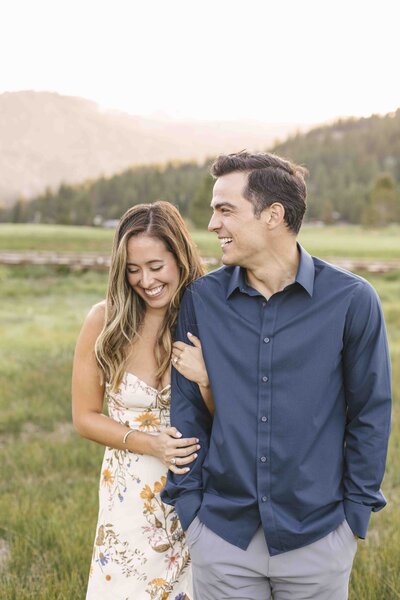 couple laughing in field