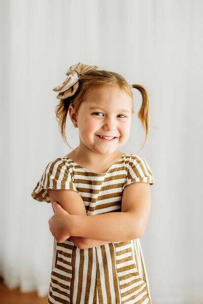 black and white personality portrait of a little girl smiling at the camera