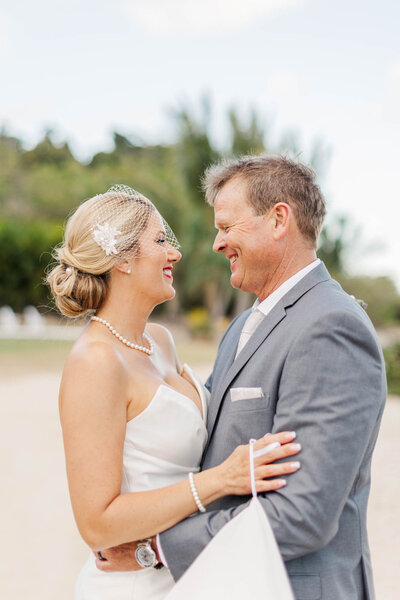 Bride and groom smiling at each other during portraits at their destination wedding venue Freedom shores