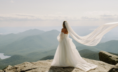 Bride looking out over a mountain view.