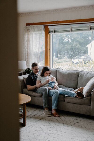 mom and dad looking at newborn