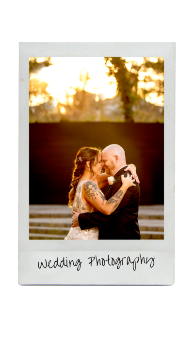 woman looking away from the camera smiles, in focus is a tattoo of a gnome with a camera on her arm