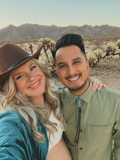 wedding photographers taking a selfie in the desert.