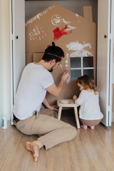 Dad playing with daughter in painted cardboard box-  Family Autism Support Coach at Chantal Hewitt Coaching