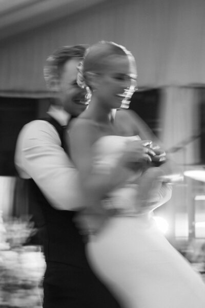 editorial style image should just a bride and grooms crossed legs while they poor a glass of champaign