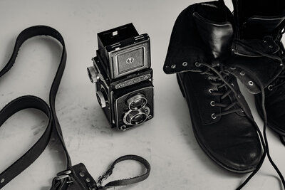 Editorial detail shot of Carrie’s boots and film camera.