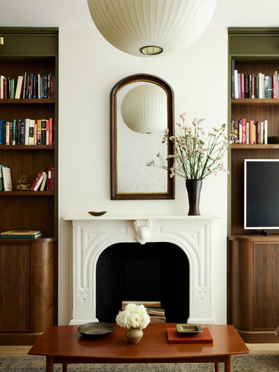 Living room fireplace in a restored Capitol Hill rowhome in Washington, DC, designed by interior design firm, Sanabria & Co.