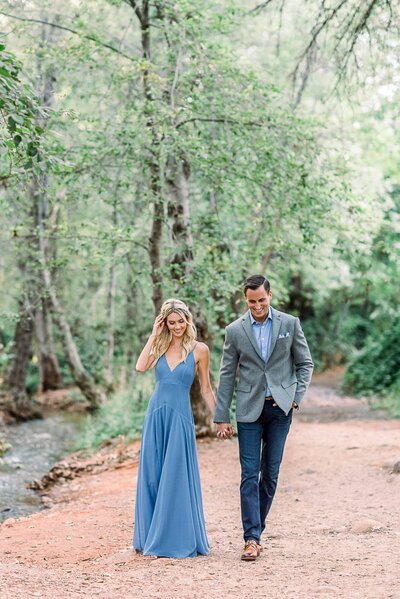 Engagement at Crescent Moon Ranch Sedona  with couple walking down path holding hands