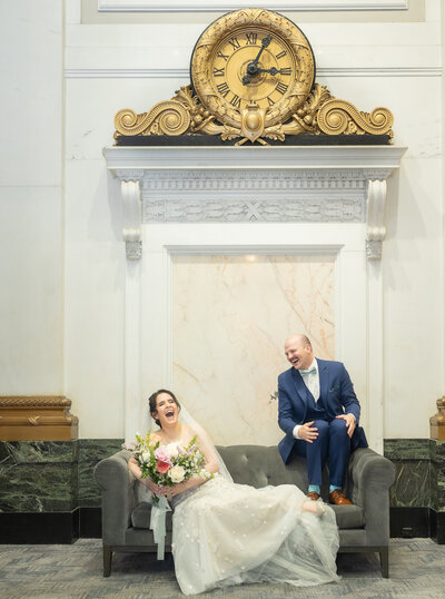 Bride and groom laugh it up on fancy couch, Balitmore Wedding Photographer 