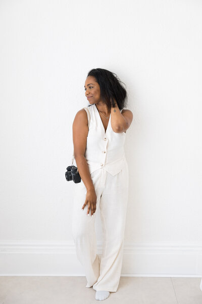 London based Family and Wedding photographer in the studio with her camera.