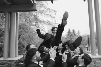 the groom celebrates with his groomsmen at his wisconsin wedding