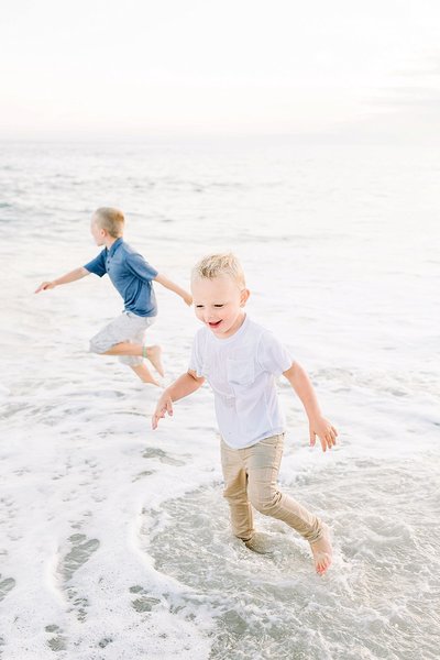 Boys playing in the water during families nantucket family photo session