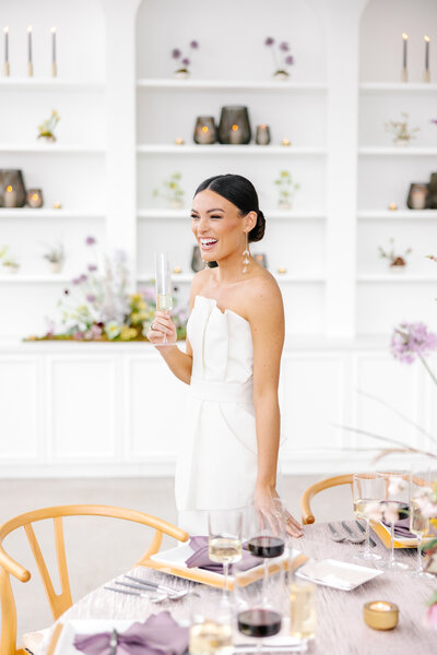 bride holding glass near wedding table by tampa wedding photographer