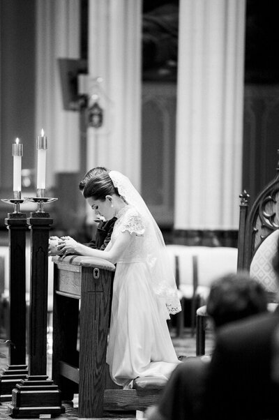 bride and groom participating in a Catholic wedding ceremony