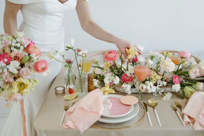 Colourful, Spring inspired wedding reception tablescape with pinks, peach, and tangerine hues, designed by Melissa Dawn Event Designs, wedding planner in Calgary, Alberta, featured on the Brontë Bride Vendor Guide.