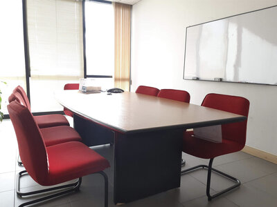 Conference table with red chairs