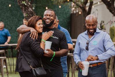 Guests hug while at a corporate event in Austin, Texas