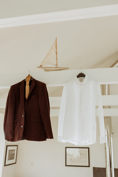 Grooms shirts hanging from beams