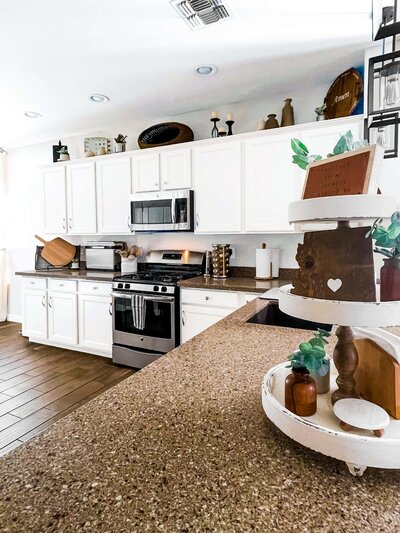 bright kitchen with white cabinets and decorative features