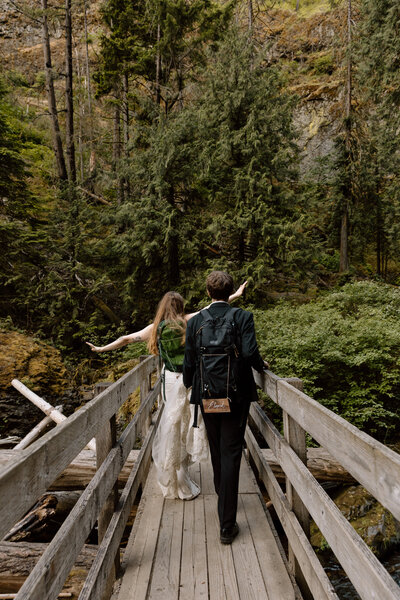 Couple walking along a bridge.