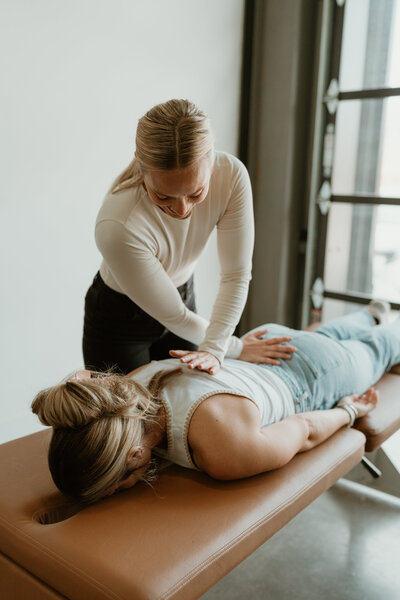 adult woman on chiropractic table getting adjusted
