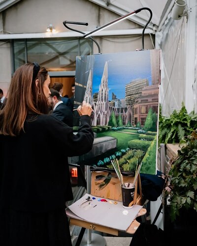 Hannah Lee - owner of Hannah Paints Events painting at a wedding