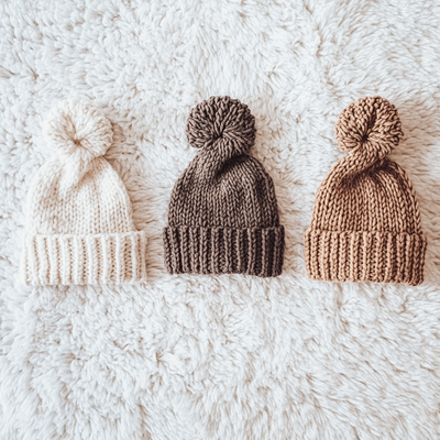 zwt8844_top_viewInstagram_styleThree_knitted_hats_on_a_white_pl_5bf399ee-3970-4bba-94c3-86967c1a9067
