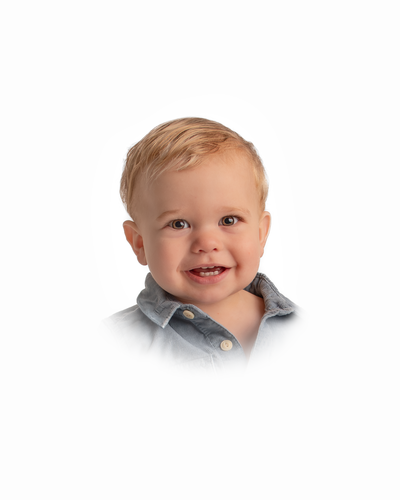 baby boy wearing collared shirt smiles for traditional portrait