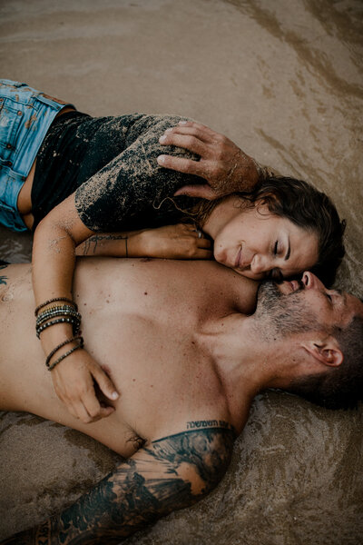 couple laying on the sand