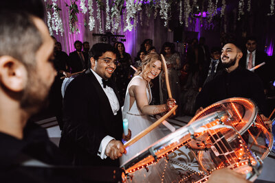 A mixed race couple partying at their reception.